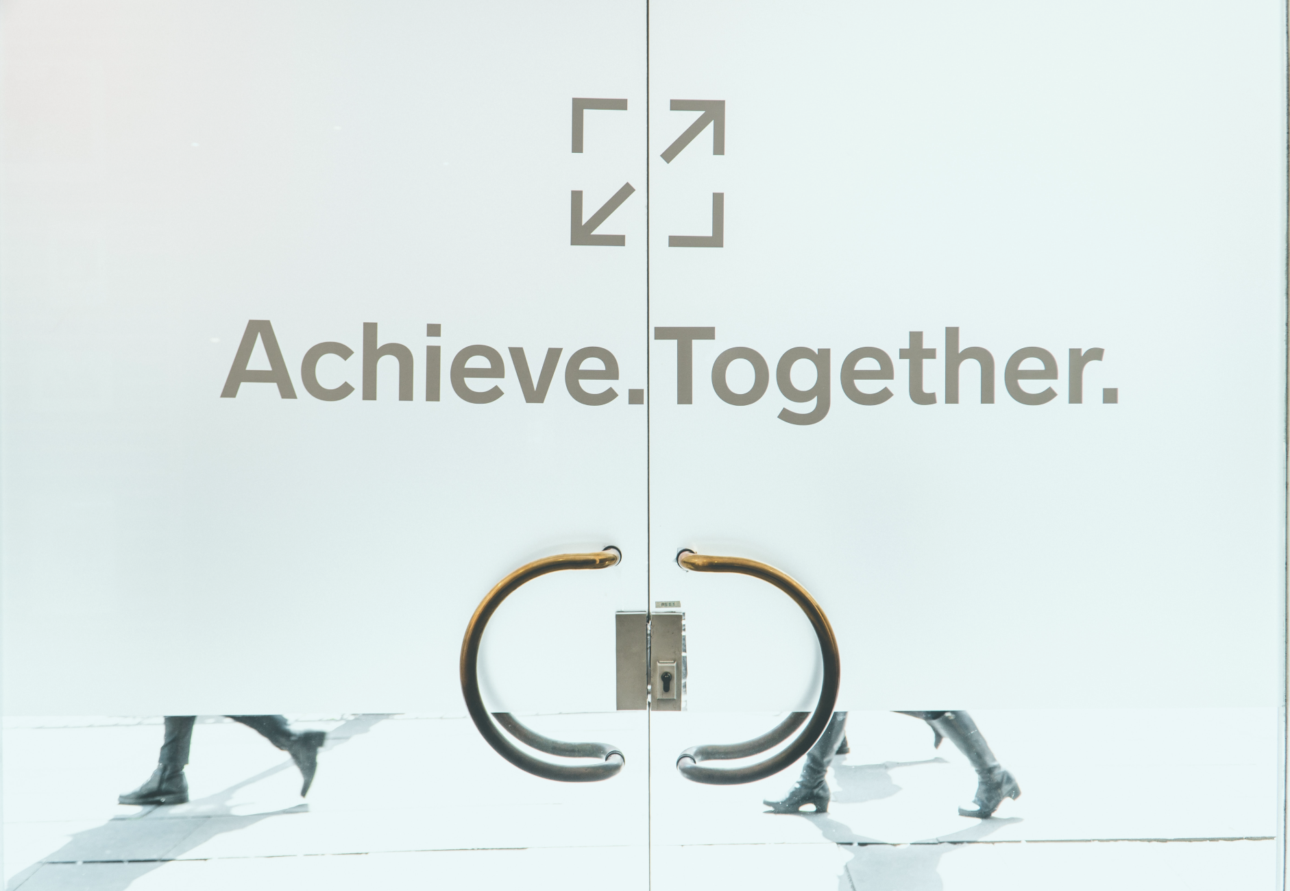 jonathan-kemper-OEpC6UQrWQU-unsplash Pic of door that says ACHIEVE TOGETHER