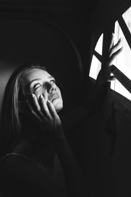 Pic of a lady losing her soul looking out of window