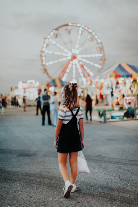Pic of a teenager lost looking at Ferris Wheel